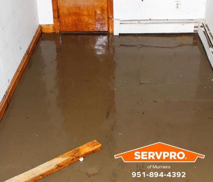 A floor is flooded with water inside a home.
